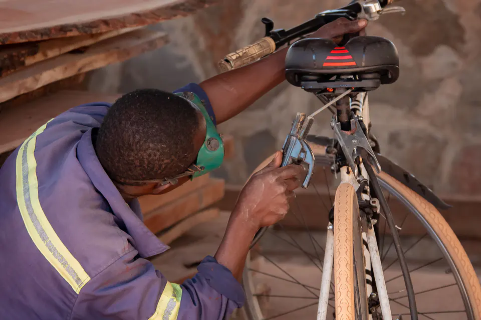 Mechanic repairing a bicycle in a workshop
