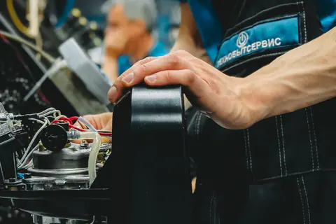 Technician repairing a coffee machine in a workshop