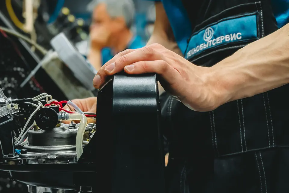 Technician repairing a coffee machine in a workshop