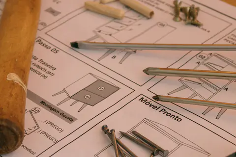 Screwdrivers and dowel pins on furniture assembly instructions